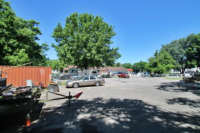 a view of an house with backyard and bushes