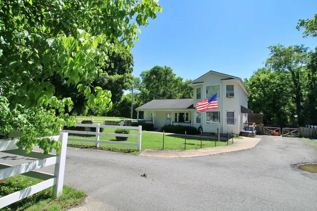 a view of a house with swimming pool and sitting area