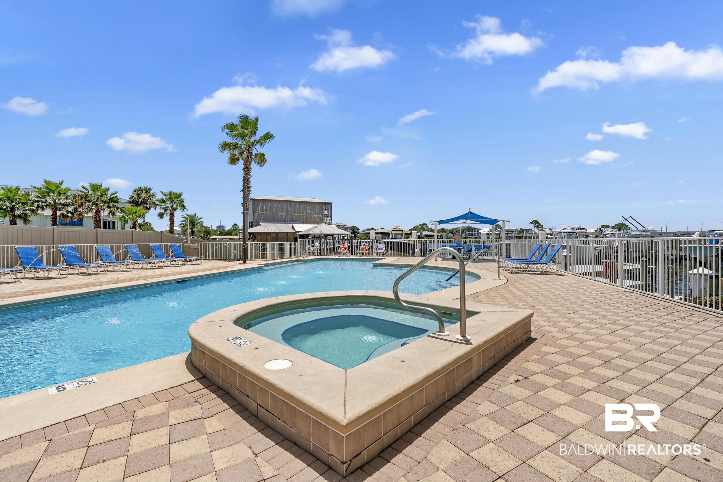 28250 Canal Road, Unit 307 Orange Beach, AL 36561 - Photo 9 of 56 Community pool featuring a patio area and a community hot tub