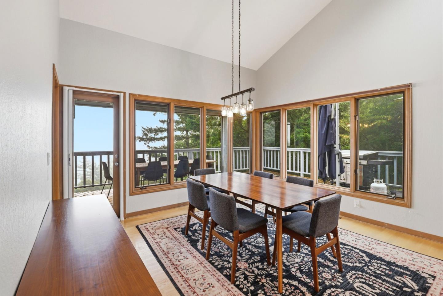 255 Allen Road Woodside, CA 94062 - Photo 16 of 42 a dining room with furniture large windows and wooden floor