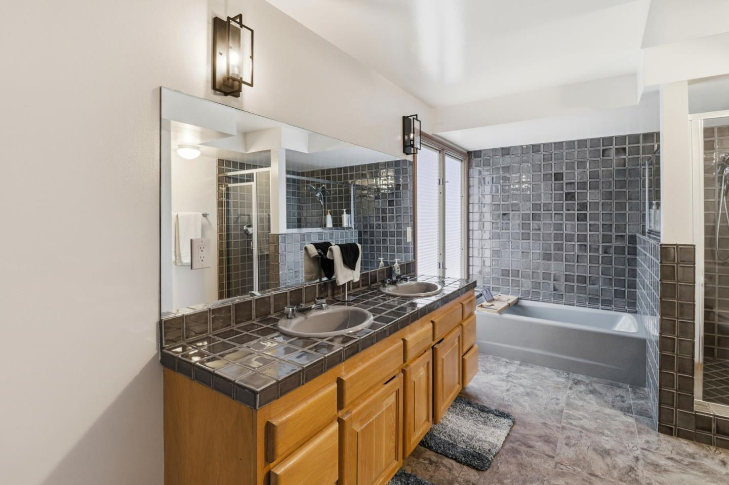 255 Allen Road Woodside, CA 94062 - Photo 22 of 42 a bathroom with a granite countertop sink a toilet a mirror and bathtub