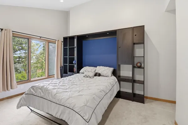 a bedroom with a bed and a night stand