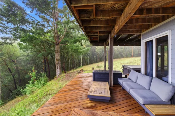 a outdoor space with patio the couches and a dining table with the view of swimming pool