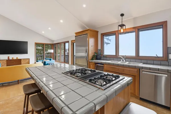 a kitchen with a stove a refrigerator and a sink