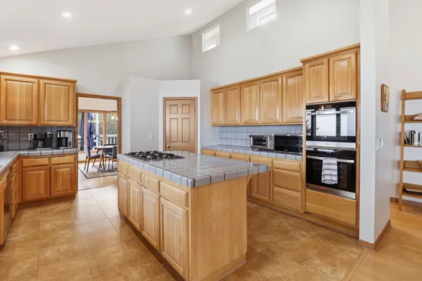 a kitchen with stainless steel appliances a stove and a microwave