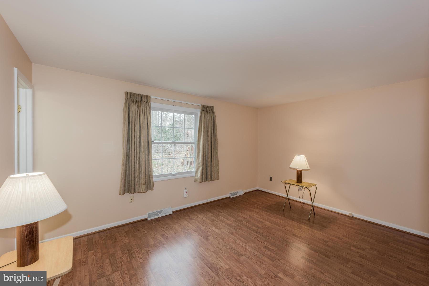 9466 Good Lion Road Columbia, MD 21045 - Photo 13 of 26 a view of an empty room with wooden floor and a window