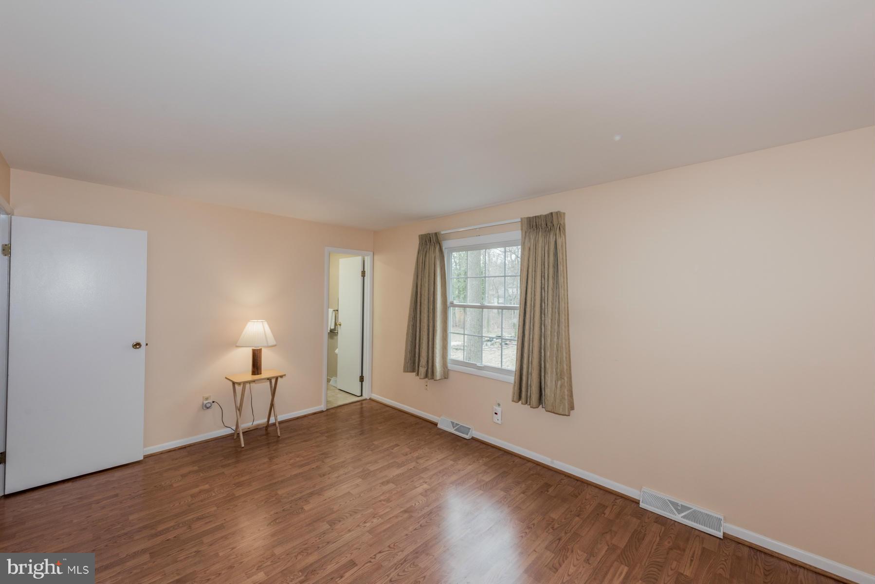 9466 Good Lion Road Columbia, MD 21045 - Photo 14 of 26 an empty room with wooden floor and windows