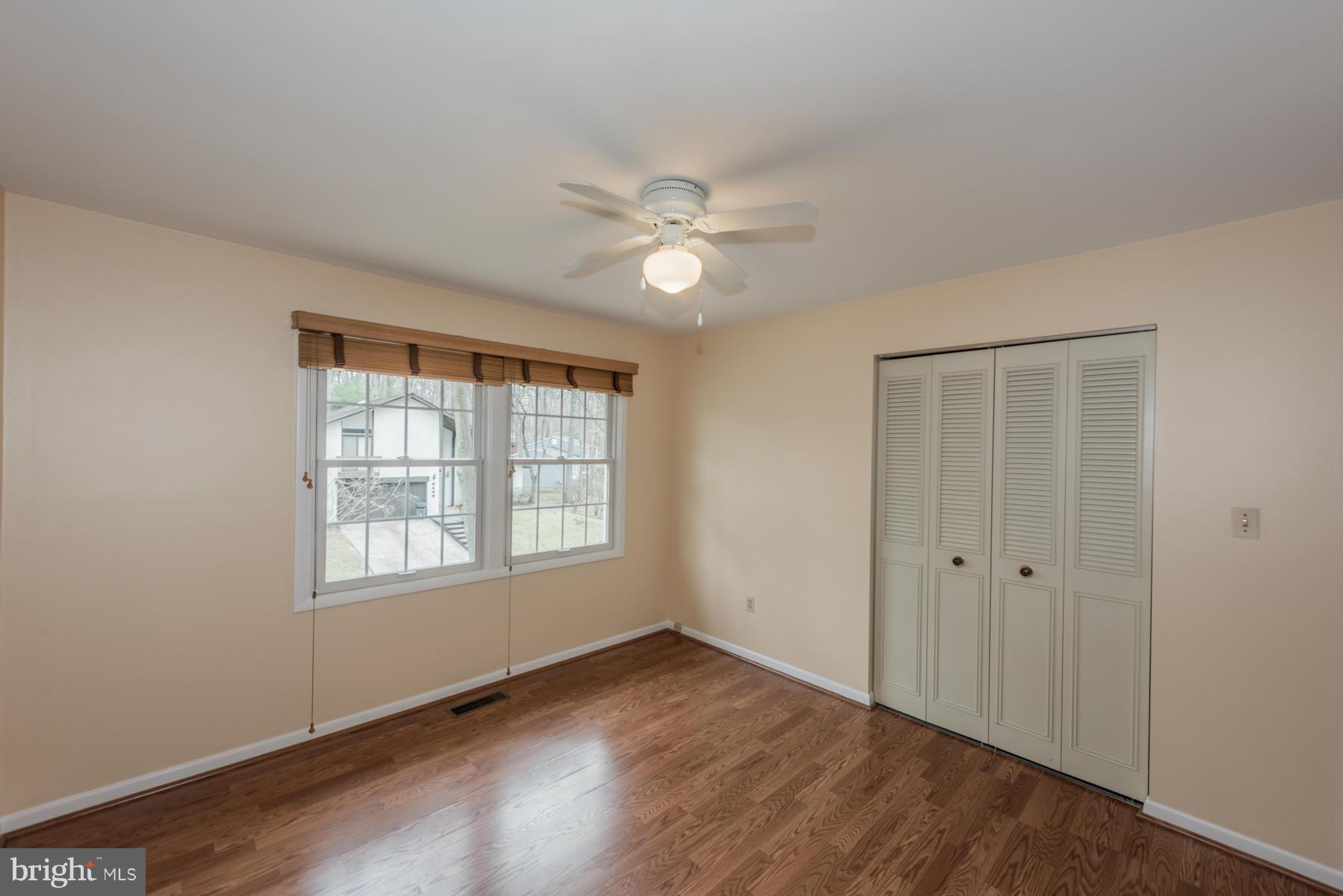 9466 Good Lion Road Columbia, MD 21045 - Photo 17 of 26 a view of an empty room with a window and wooden floor