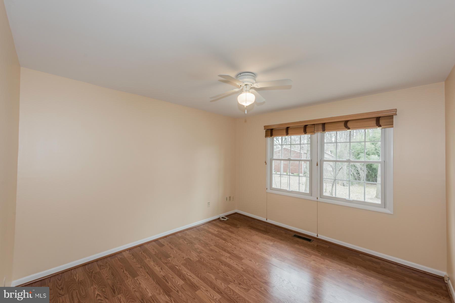 9466 Good Lion Road Columbia, MD 21045 - Photo 18 of 26 an empty room with wooden floor and windows