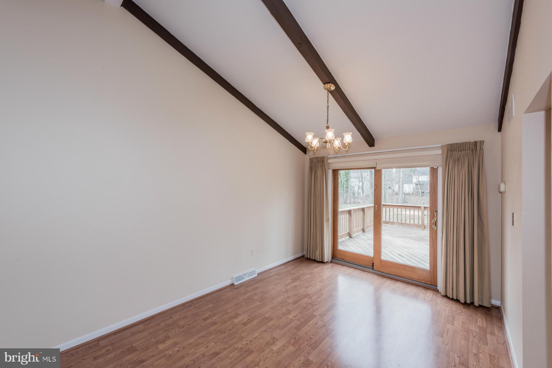 9466 Good Lion Road Columbia, MD 21045 - Photo 8 of 26 an empty room with wooden floor and windows