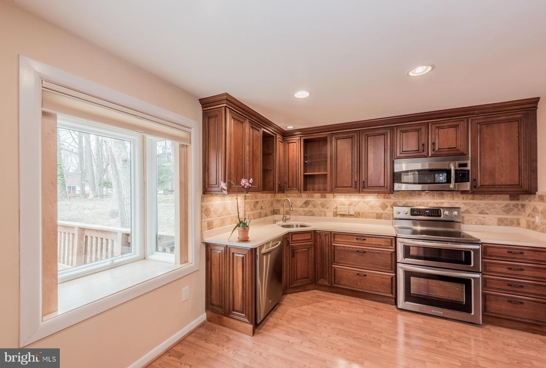9466 Good Lion Road Columbia, MD 21045 - Photo 9 of 26 a kitchen with stainless steel appliances granite countertop a stove and a sink