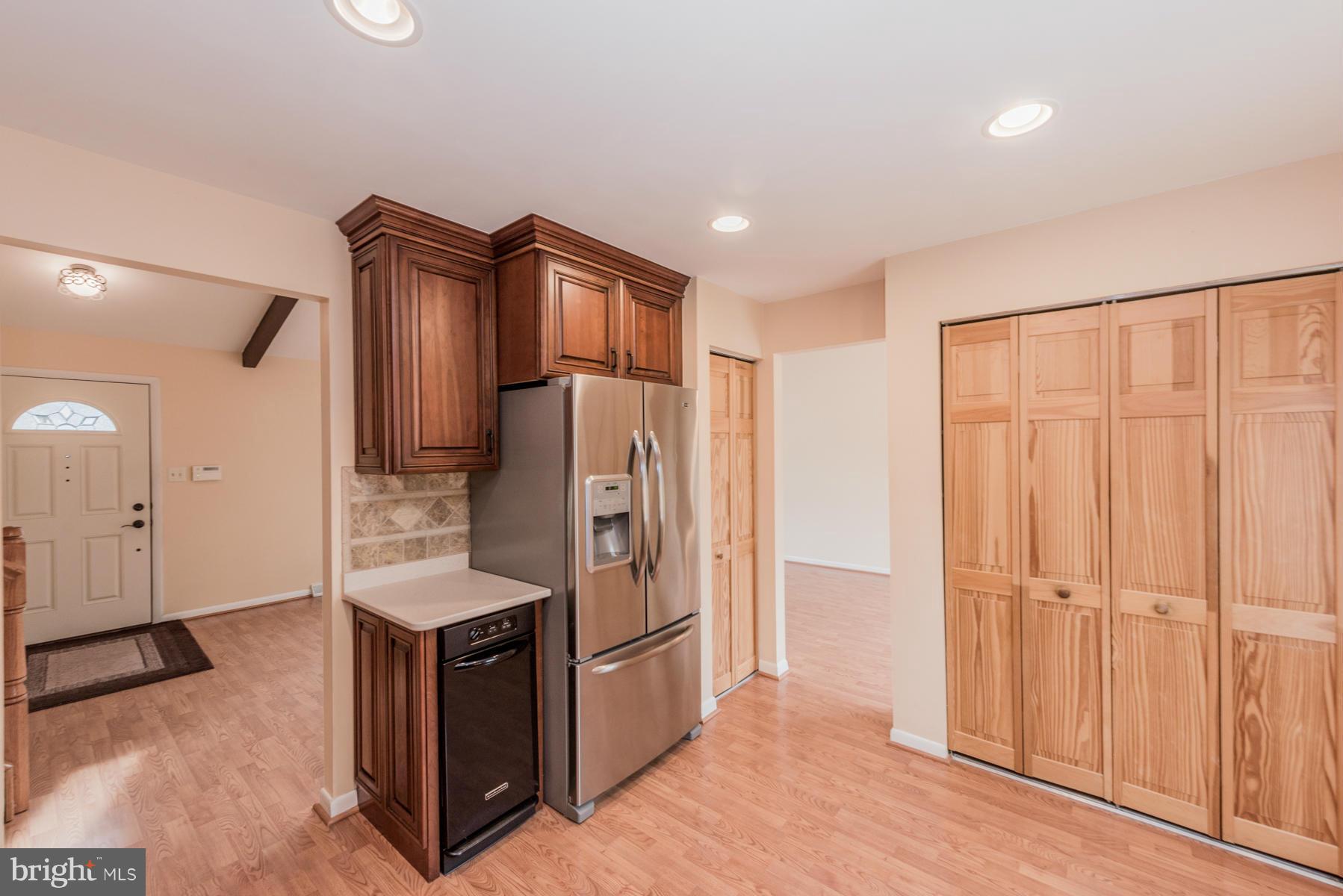 9466 Good Lion Road Columbia, MD 21045 - Photo 10 of 26 a kitchen with stainless steel appliances a refrigerator and cabinets