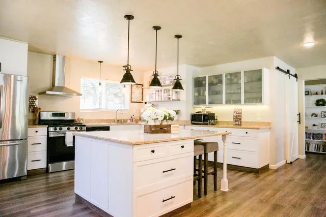 a kitchen with a sink stove and refrigerator