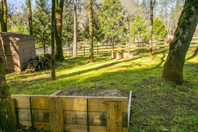 a backyard of a house with yard and outdoor seating