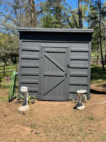 a view of a swimming pool with a yard and seating area