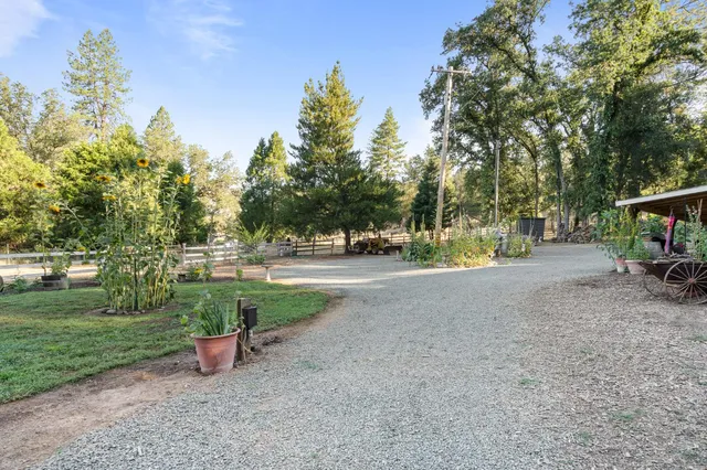 a view of a house with a yard and sitting area
