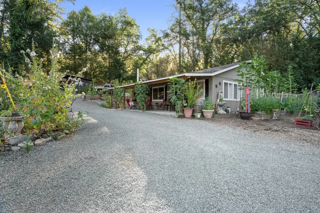 a living room with furniture kitchen view and a large window