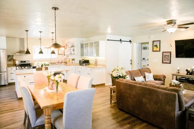 a kitchen with sink a stove and chairs