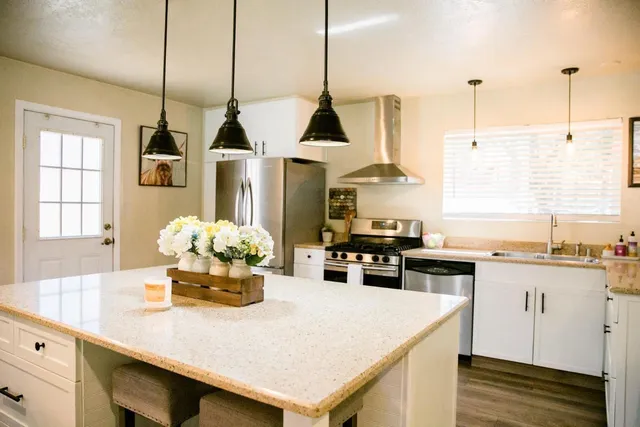 a kitchen with white cabinets and white appliances