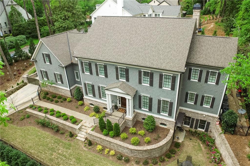 955 West Wesley Road Northwest Atlanta, GA 30327 - Photo 1 of 1 a aerial view of a house with swimming pool and trees in the background