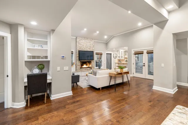 a living room with furniture wooden floor and a table