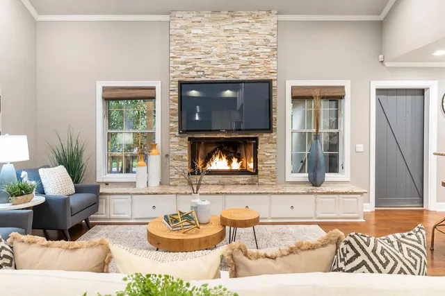 a living room with furniture and a view of kitchen