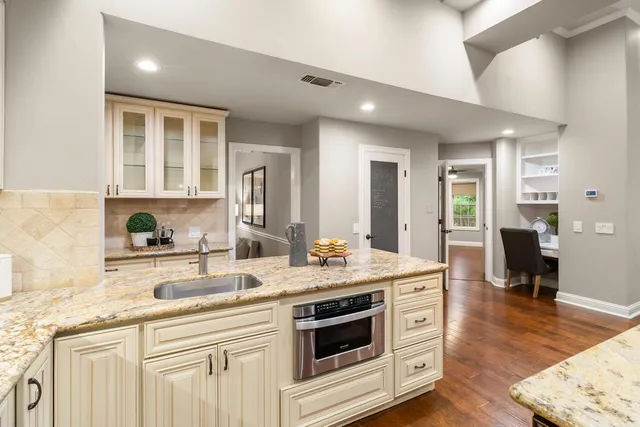 a bathroom with a granite countertop sink mirror and shower