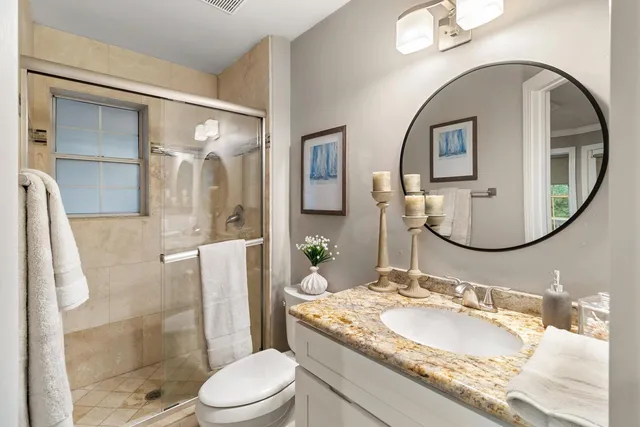 a front view of a house with a garden and plants