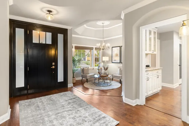 a living room with furniture and a chandelier