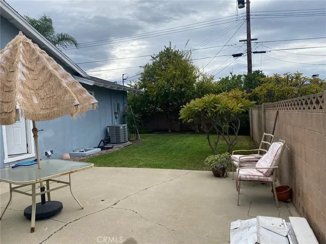 a view of a patio with a table and chairs