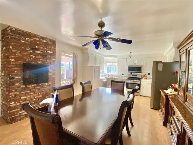 a dining room with furniture a window and kitchen view