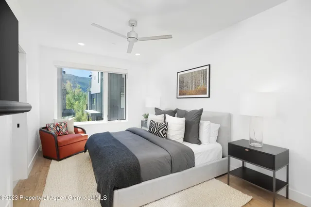 a bedroom with a bed couch and window