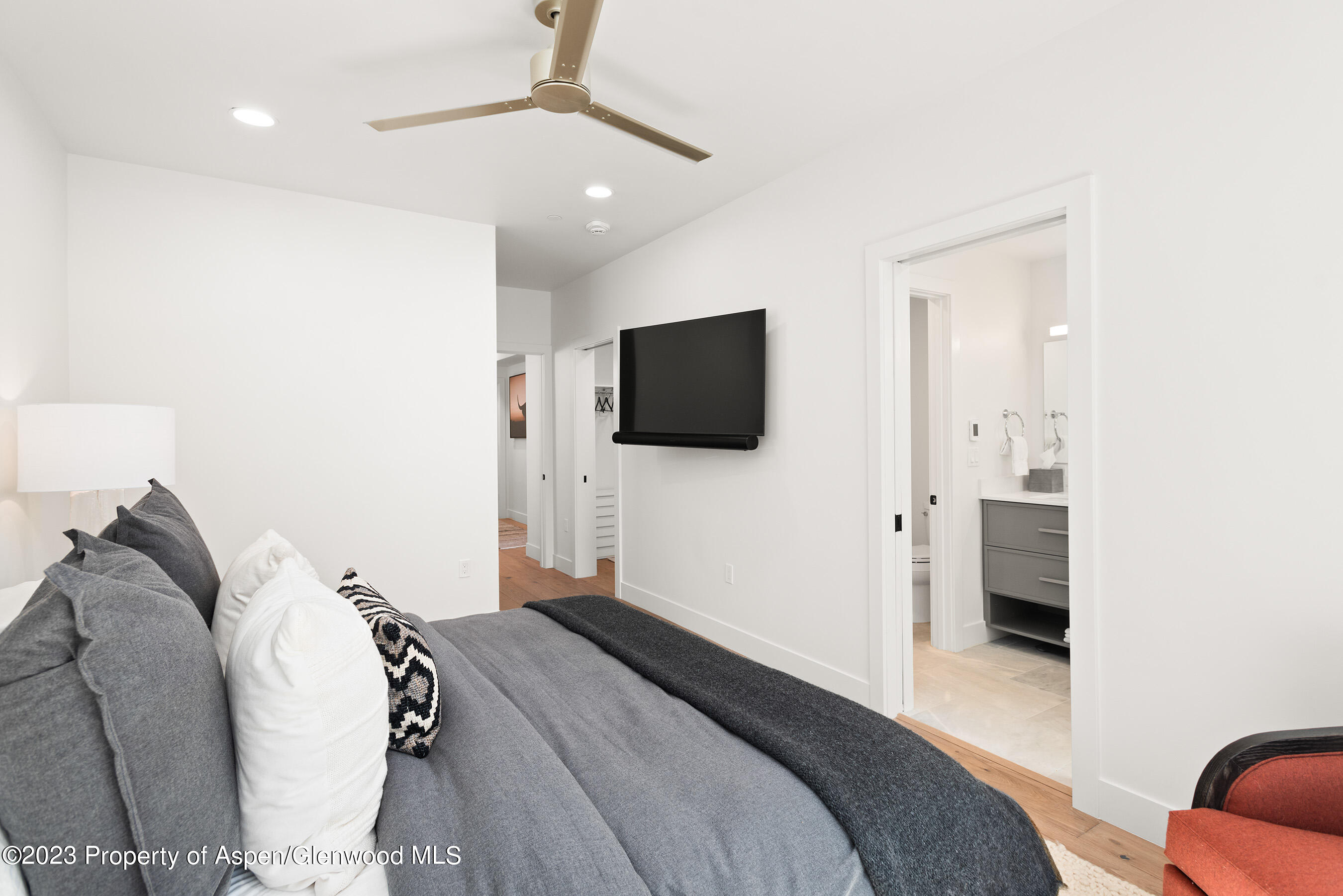 22842 Two Rivers Road, Unit 100 Basalt, CO 81621 - Photo 13 of 22 a bedroom with a bed and a flat screen tv
