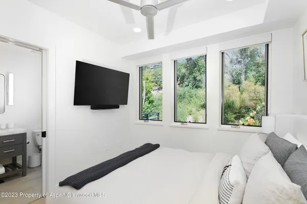 a bathroom with a granite countertop sink toilet mirror and shower