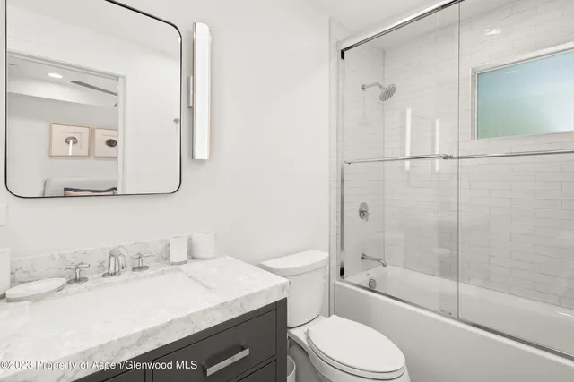 a bedroom with a bed lamp and window