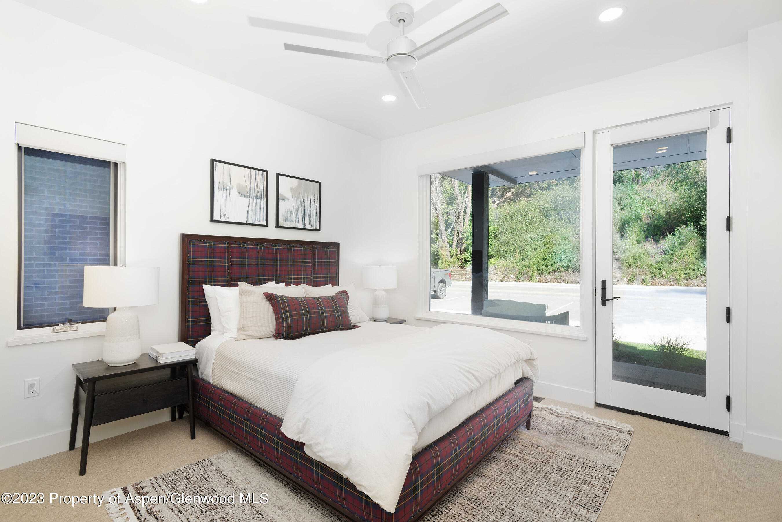 22842 Two Rivers Road, Unit 100 Basalt, CO 81621 - Photo 18 of 22 a bedroom with a bed lamp and window