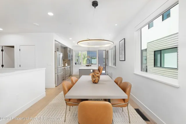 a view of a dining room with furniture and wooden floor