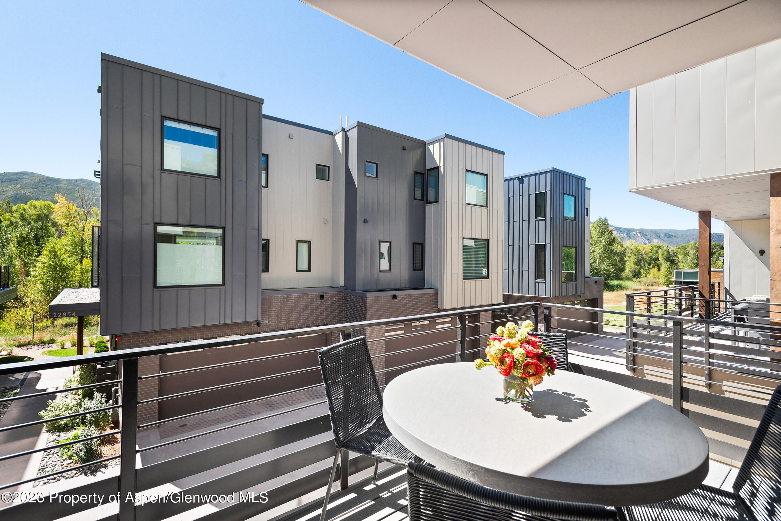 22842 Two Rivers Road, Unit 100 Basalt, CO 81621 - Photo 9 of 22 a view of a dining room with furniture window and wooden floor