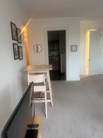 a view of a livingroom with wooden floor and white walls