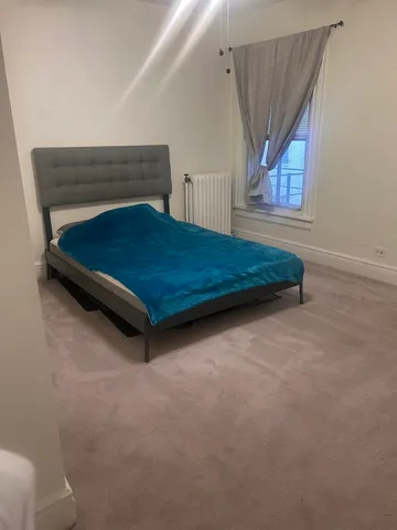 a bedroom with a bed and window