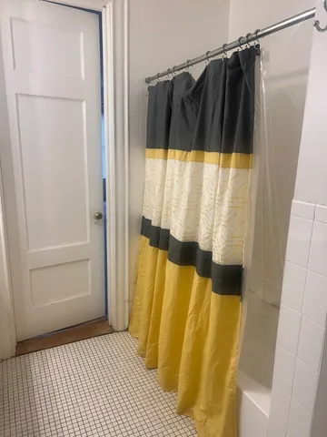 a bathroom with a shower and a toilet