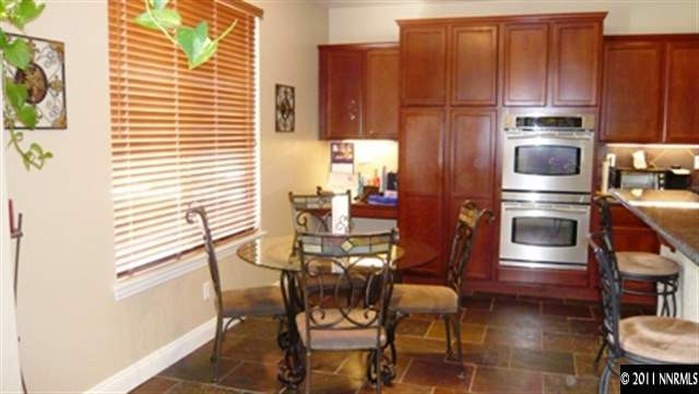 615 Royal Windsor Court Reno, NV 89521 - Photo 3 of 13 a kitchen with stainless steel appliances granite countertop a stove and a refrigerator