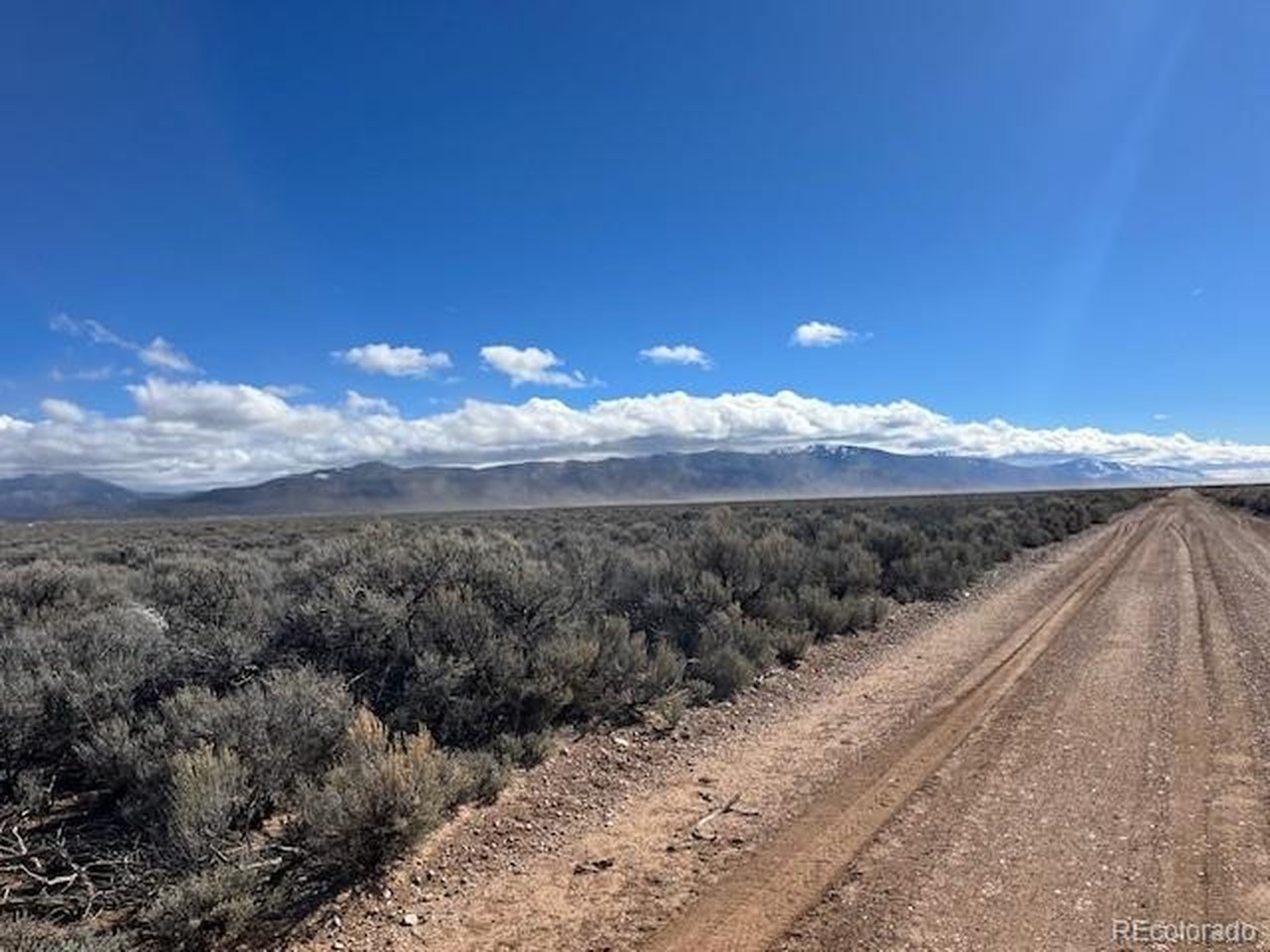 12 County Road East San Luis, CO 81152 - Photo 7 of 12 a view of a yard with wooden fence
