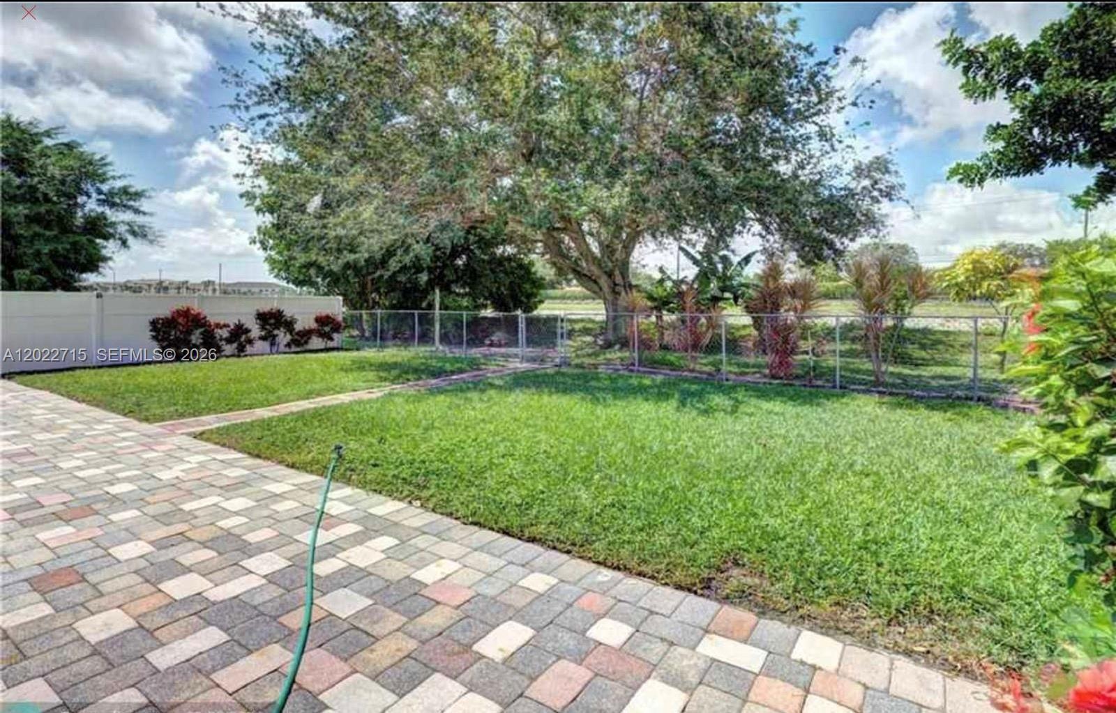 10669 Boca Entrada Boulevard Boca Raton, FL 33428 - Photo 19 of 19 a view of a backyard with a garden