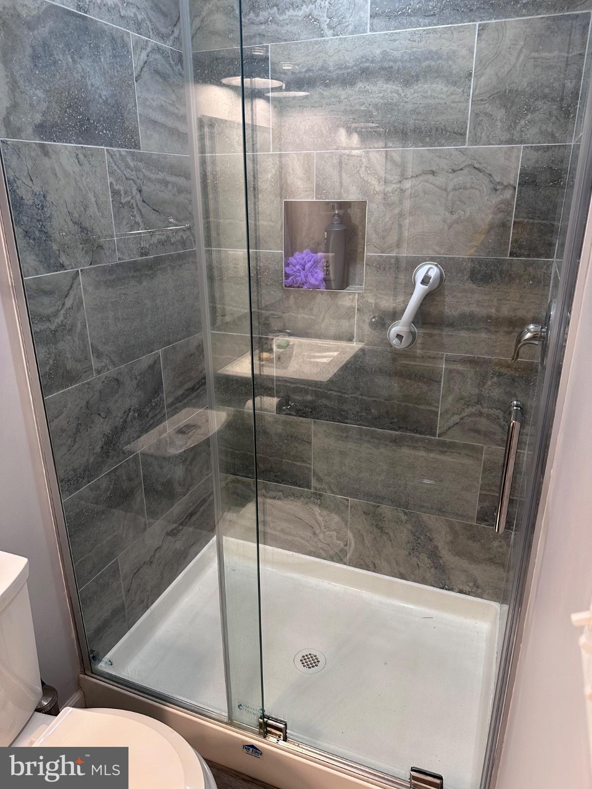 902 B Edgerly Road Glen Burnie, MD 21060 - Photo 5 of 12 Sleek modern shower with elegant tiles.