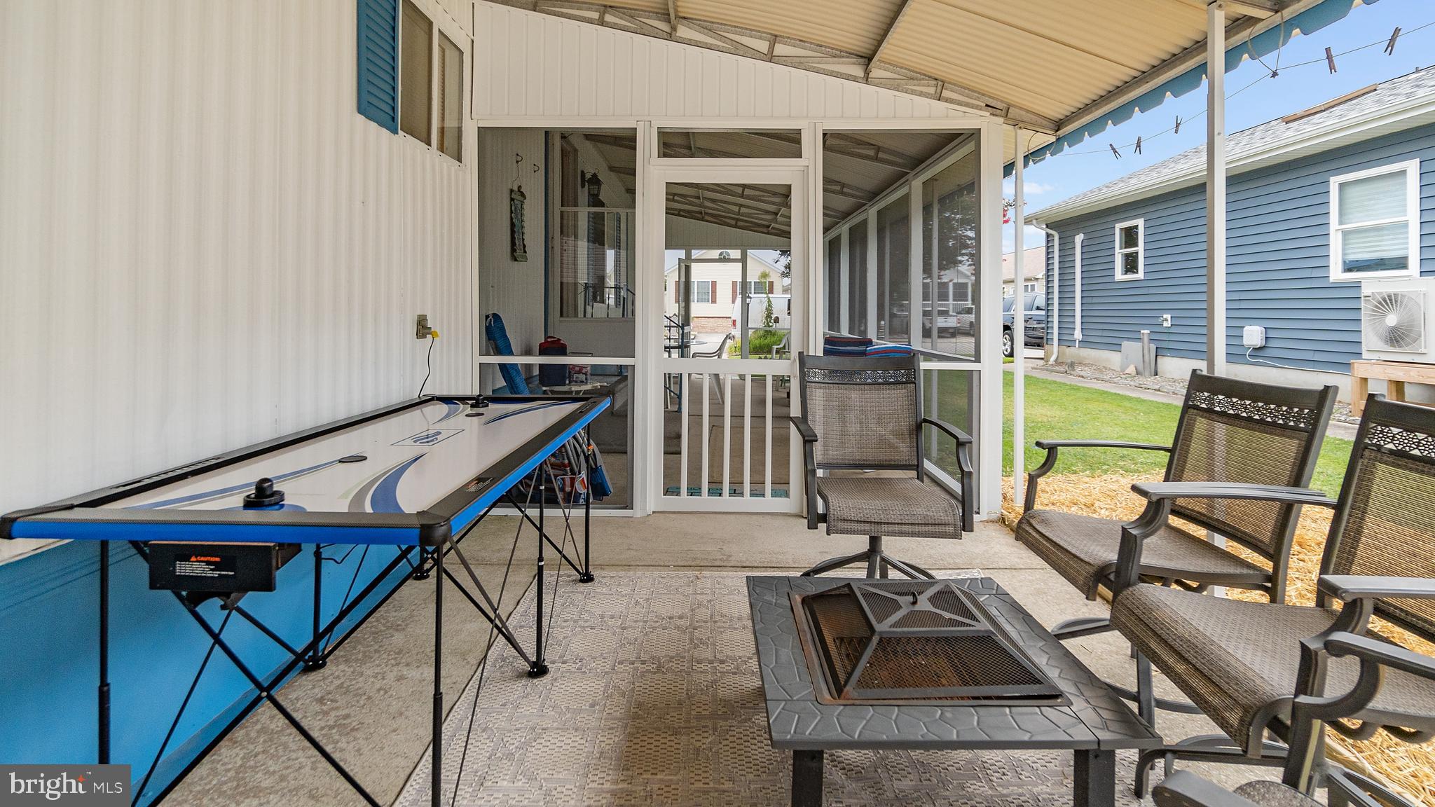 13324 Nantucket Road Ocean City, MD 21842 - Photo 15 of 45 a patio with table and chairs