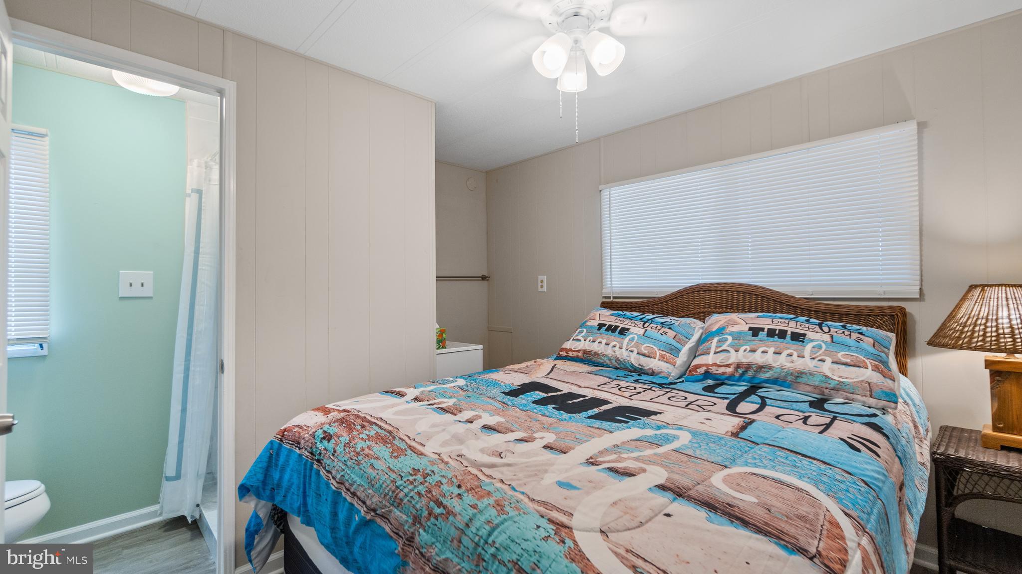 13324 Nantucket Road Ocean City, MD 21842 - Photo 19 of 45 a bedroom with a bed and a chandelier