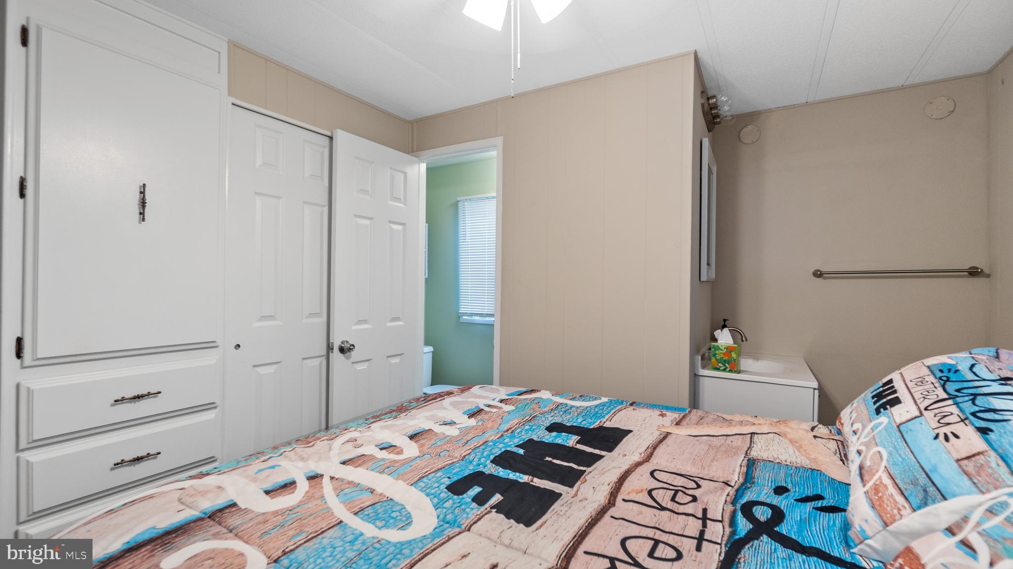 13324 Nantucket Road Ocean City, MD 21842 - Photo 21 of 45 a bedroom with a bed and a dresser in it