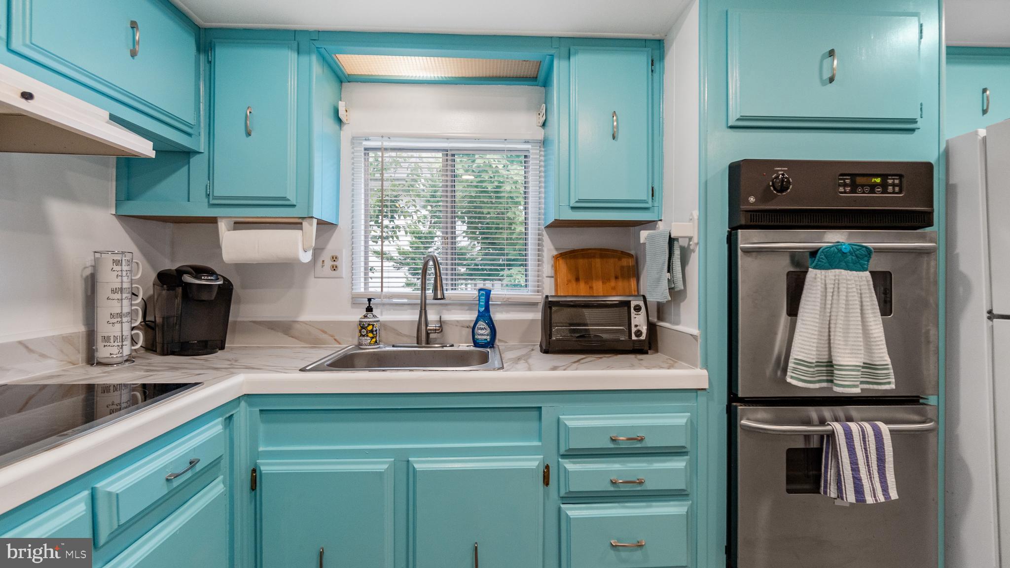 13324 Nantucket Road Ocean City, MD 21842 - Photo 24 of 45 a kitchen with stainless steel appliances granite countertop a sink stove and cabinets