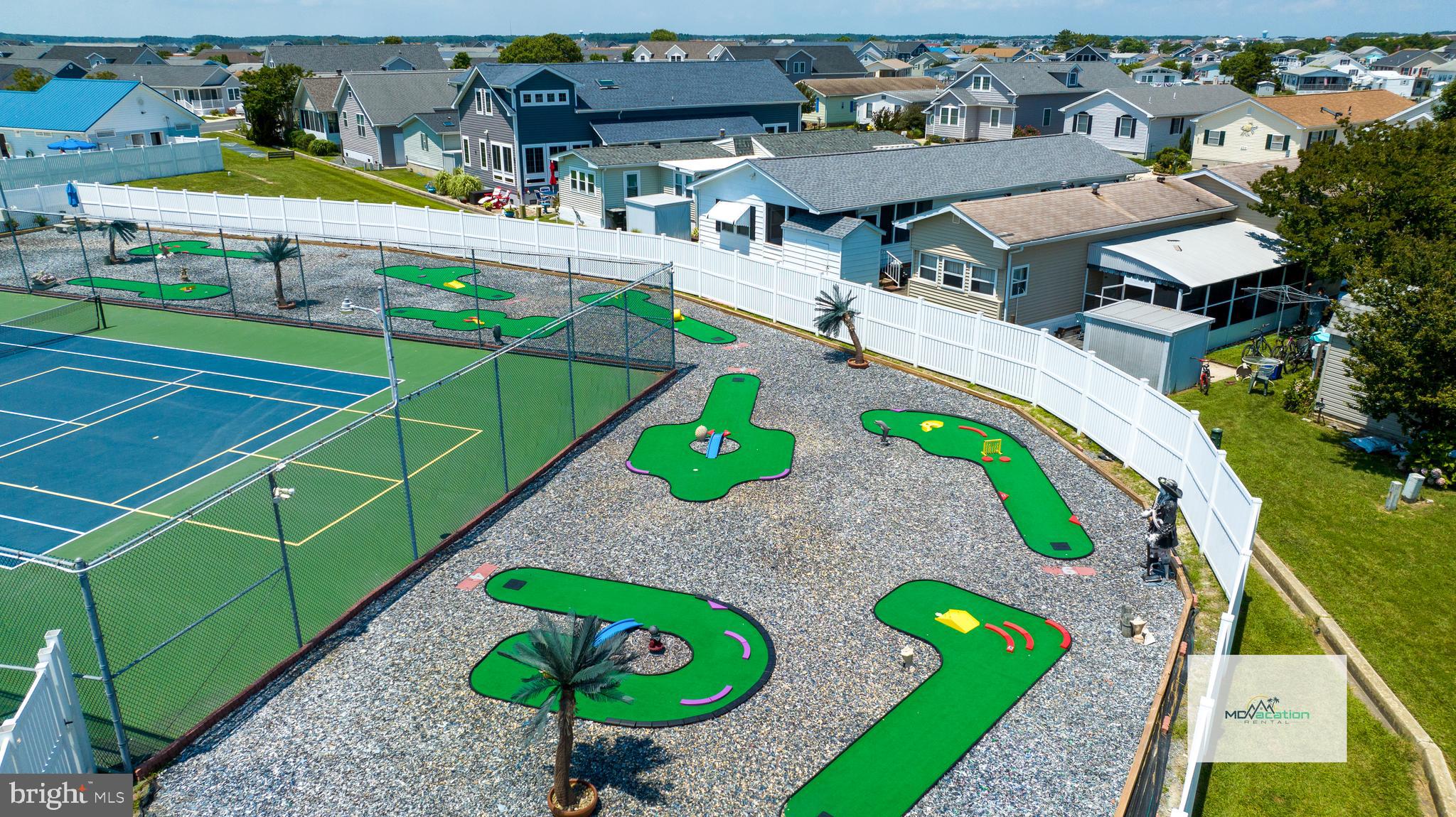 13324 Nantucket Road Ocean City, MD 21842 - Photo 31 of 45 an aerial view of a tennis ground with large trees